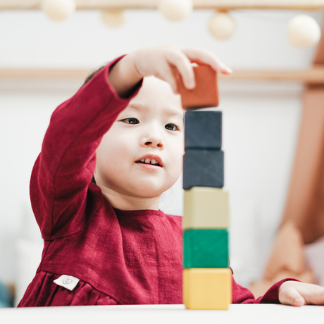 young child stacking blocks