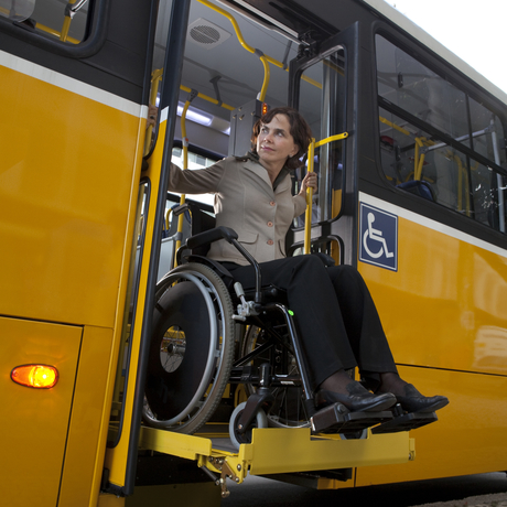 Person exiting a lift-equipped bus in a wheelchair.