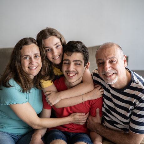 Portrait of a family at home, with their son who has autism.