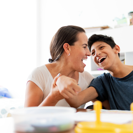 Mother drawing with son with Cerebral Palsy.