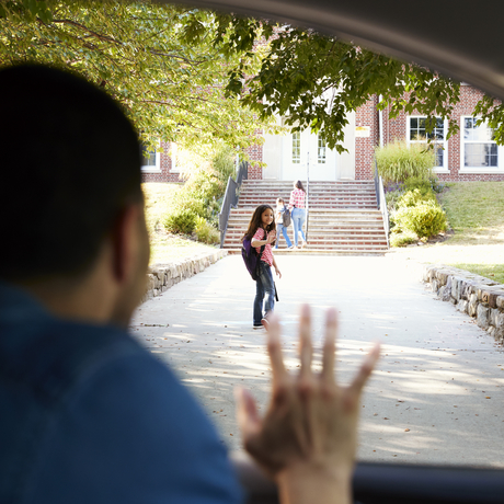 Father In Car Dropping Off Daughter In Front Of School Gates.