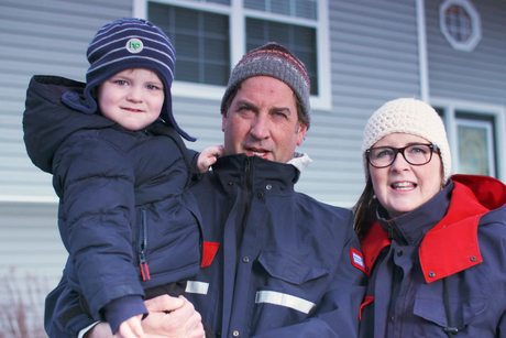 Postal worker parent, holding child.